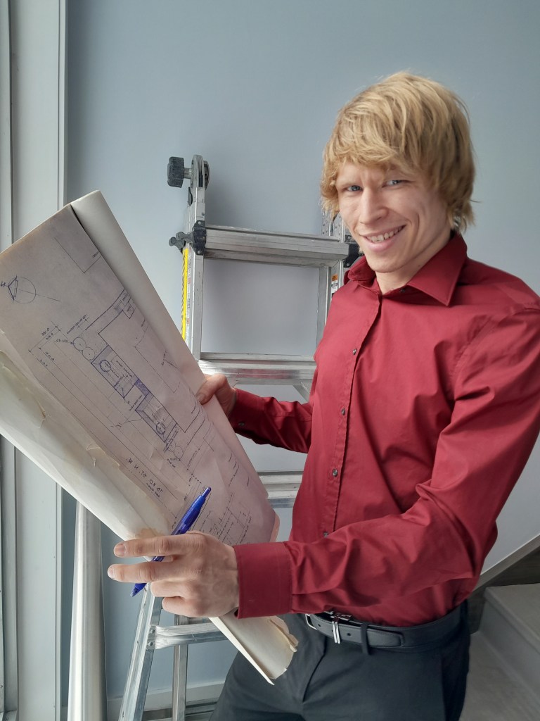 Construction worker holding a map with design plans. 